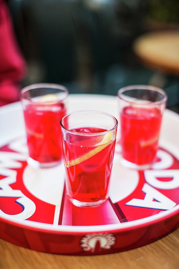 Three Glasses Of Campari Photograph by Helen Cathcart