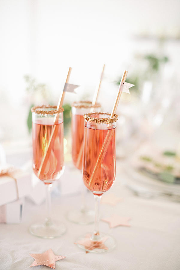 Three Gold-rimmed Glasses Of Pink Sparkling Wine With Straws Photograph by Katja Heil