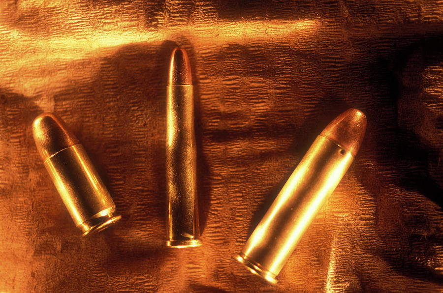 Three Golden 38 Calibre Bullets Photograph by Lyle Leduc