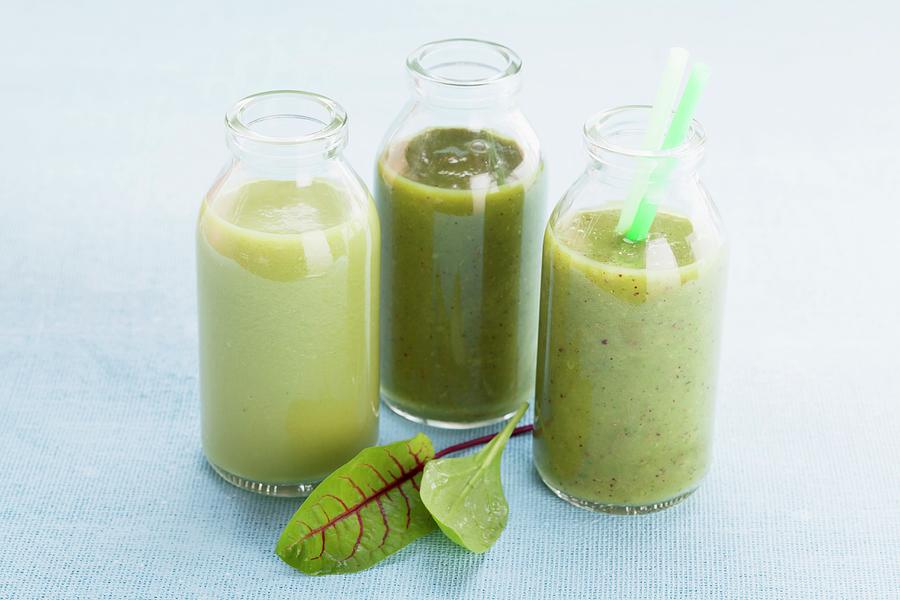 Three Green Smoothies In Glass Bottles Photograph by Eising Studio - Food Photo & Video