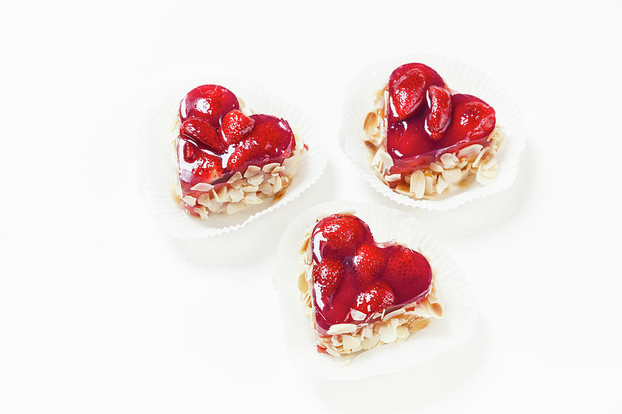 Three Heart-shaped Strawberry And Almond Tarts Photograph by Anneliese Kompatscher
