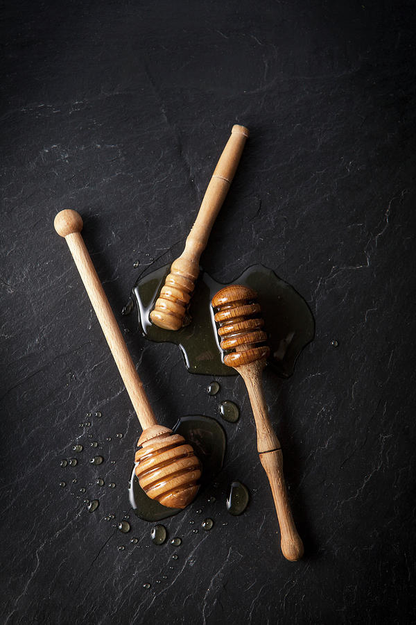 Three Honey Dippers With Honey On A Black Slate Photograph by Stacy Grant