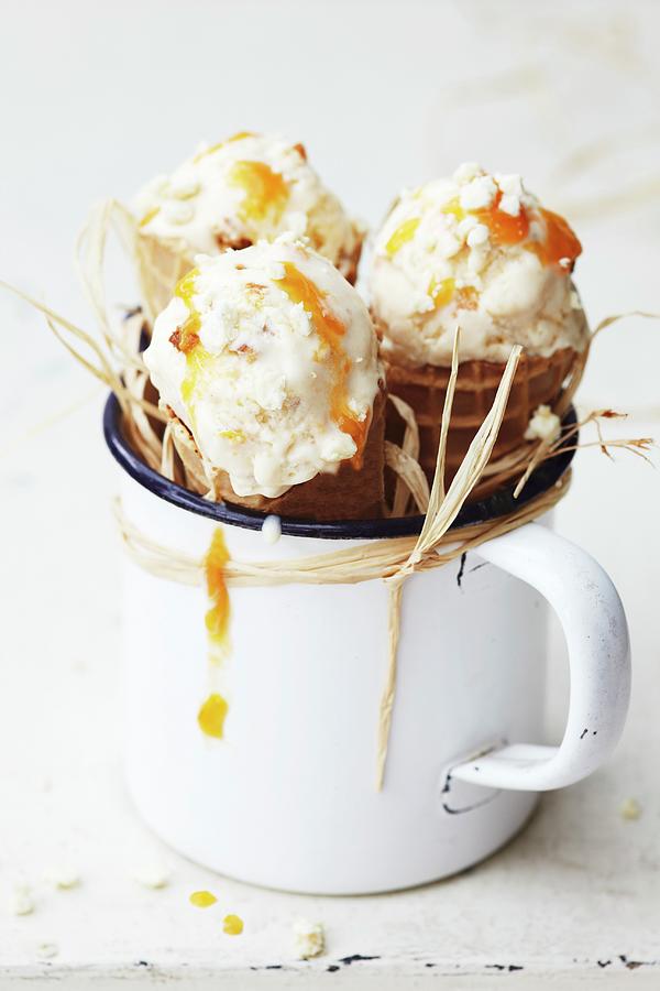 Three Ice Cream Cones With Apricot Ice Cream In An Enamel Mug Photograph by Susanne Schanz