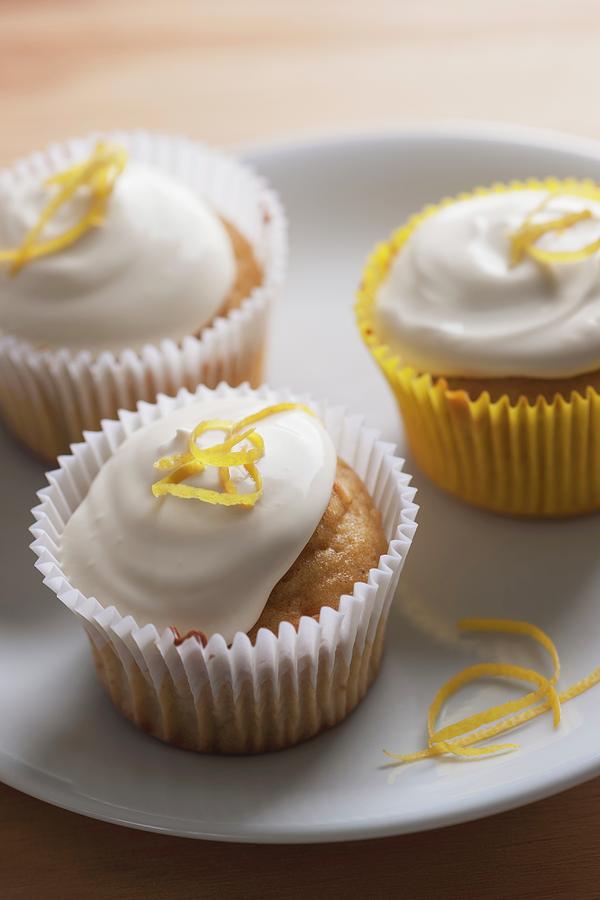 Three Lemon Cupcakes With Cream And Lemon Zest Photograph by Laurange