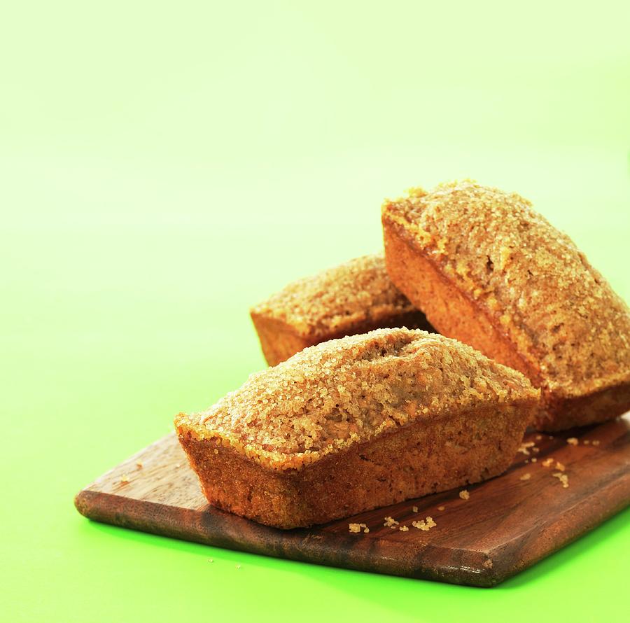 Three Loaves Of Banana Bread On A Wooden Board Photograph by Jim Norton