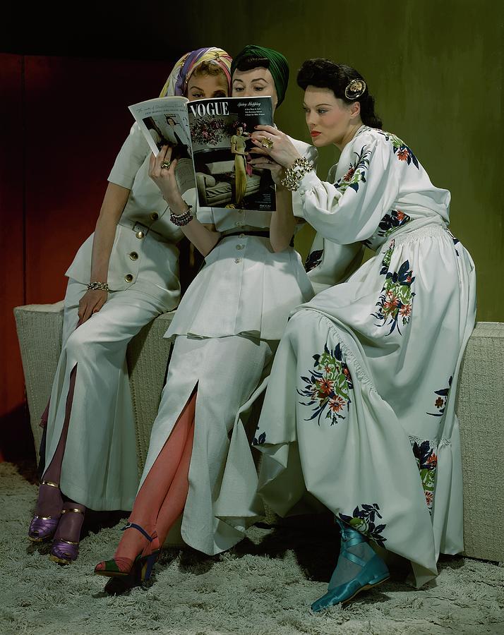 Three Models Reading Vogue Photograph by John Rawlings