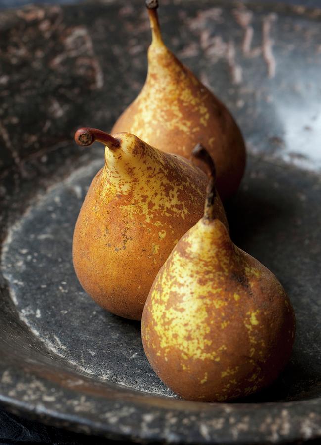Three Organic Conference Pears In A Stone Bowl Photograph by Hilde Mche