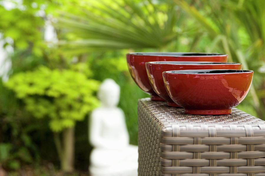 Three Red Painted Bowls From The Burma In An Oriental Garden Photograph by Mohrimages