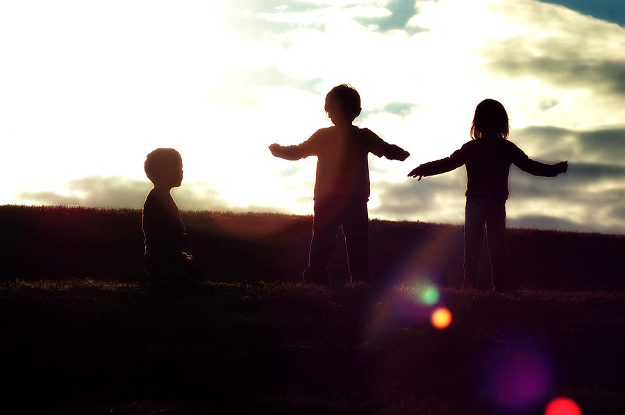 Three Silhouetted Children In The Sun Photograph by Meredith Winn Photography
