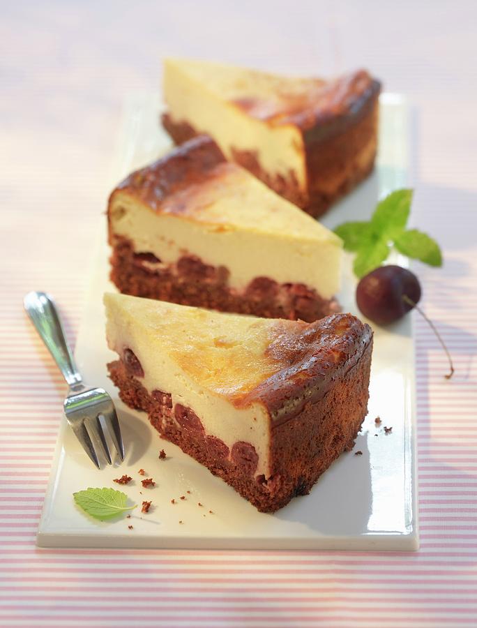 Three Slices Of Chocolate And Cherry Cheesecake Photograph by Foodfoto Kln