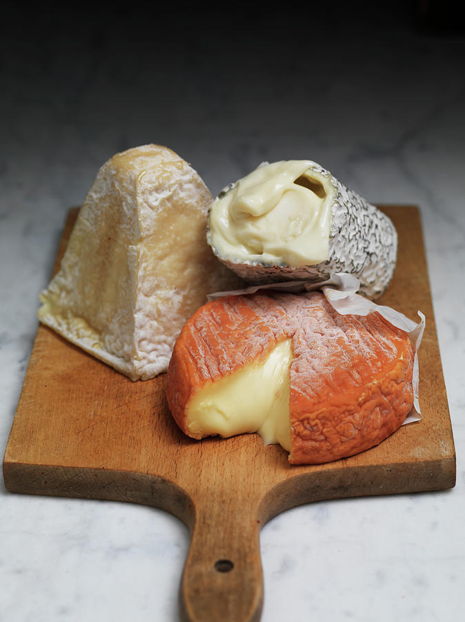 Three Soft Cheeses On A Wooden Board Photograph by Hugh Johnson
