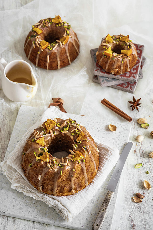 Three Spice Ring Cake With A Glaze And Pistachios Photograph by M. Nlke