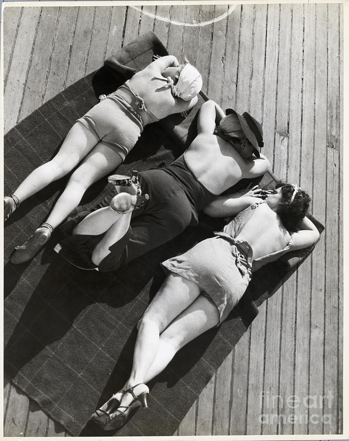 Three Sunbathers On Towel On Deck Photograph by Bettmann