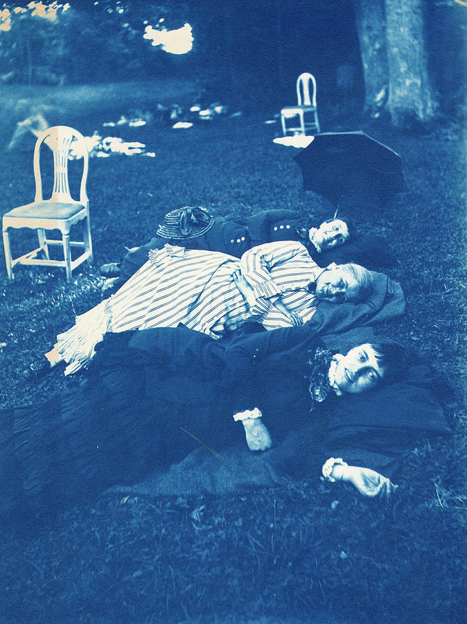 Three women lying in the grass, the one in the top of the picture is Calla Curman, wife of Carl Curm Painting by Celestial Images
