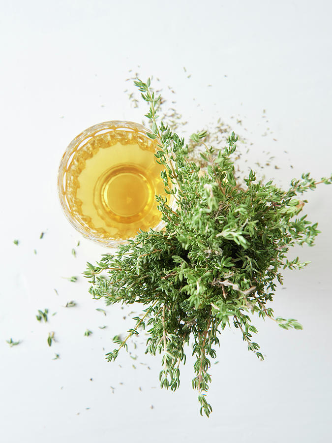 Thyme Tea In A Glass Next To Fresh Thyme Photograph by Hannah Kompanik