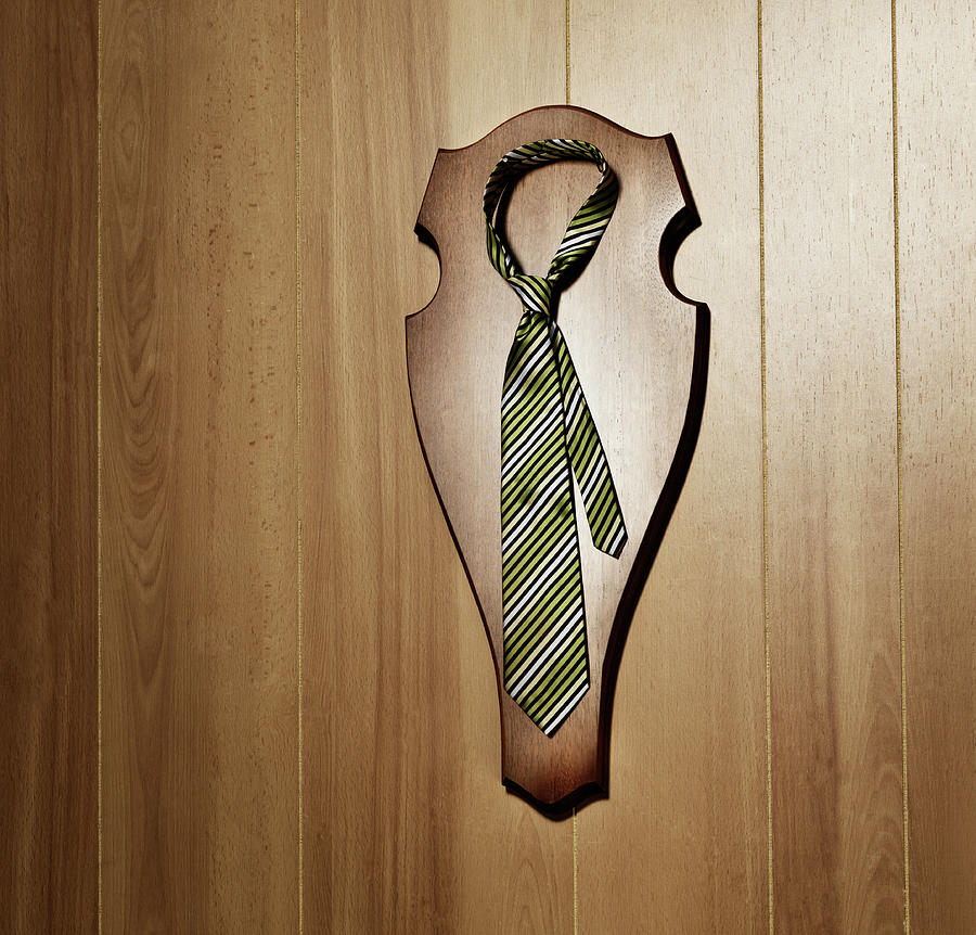 Tie With Knot Hanging As A Trophy On A Photograph by Henrik Sorensen