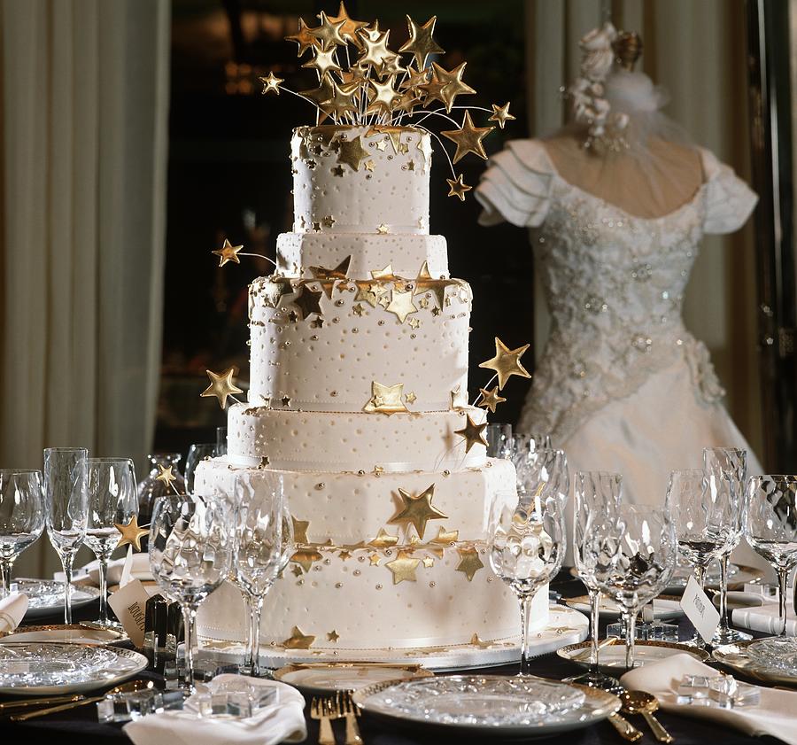 Tiered Wedding Cake With Gold Stars On A Set Table Photograph by Cooke, Colin