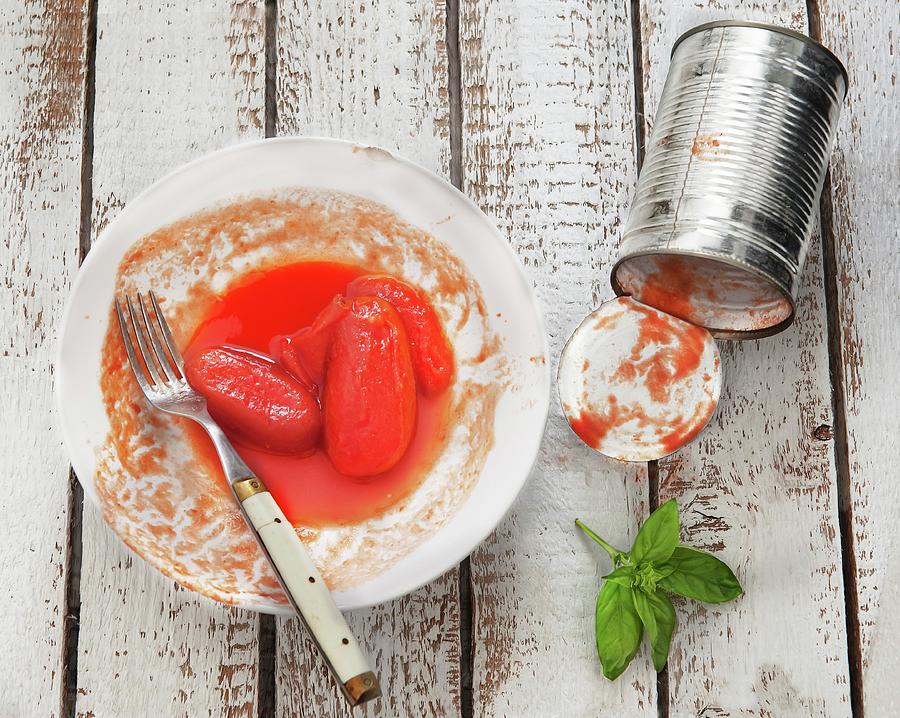 Tinned Tomatoes On A Plate With The Empty Tin Next To It Photograph by Piga & Catalano S.n.c.