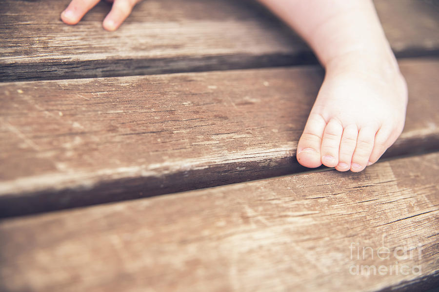 Tiny hands and feet of a baby, retro style. Photograph by Joaquin Corbalan