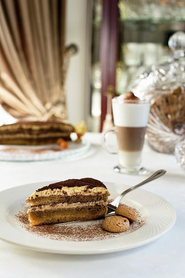 Tiramisu Cake With Mascarpone Mousse, Topped With Coffee And Cocoa Powder And Served With Almond Biscotti Photograph by Tomasz Jakusz