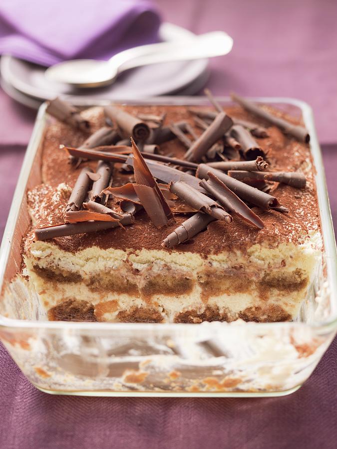 Tiramisu Topped With Chocolate Curls, In A Glass Dish, Part Already Served Photograph by Foodcollection