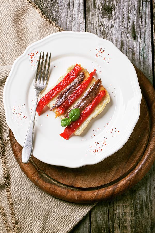 Toast Topped With Grilled Pepper And Anchovies On A Plate Photograph by Natasha Breen