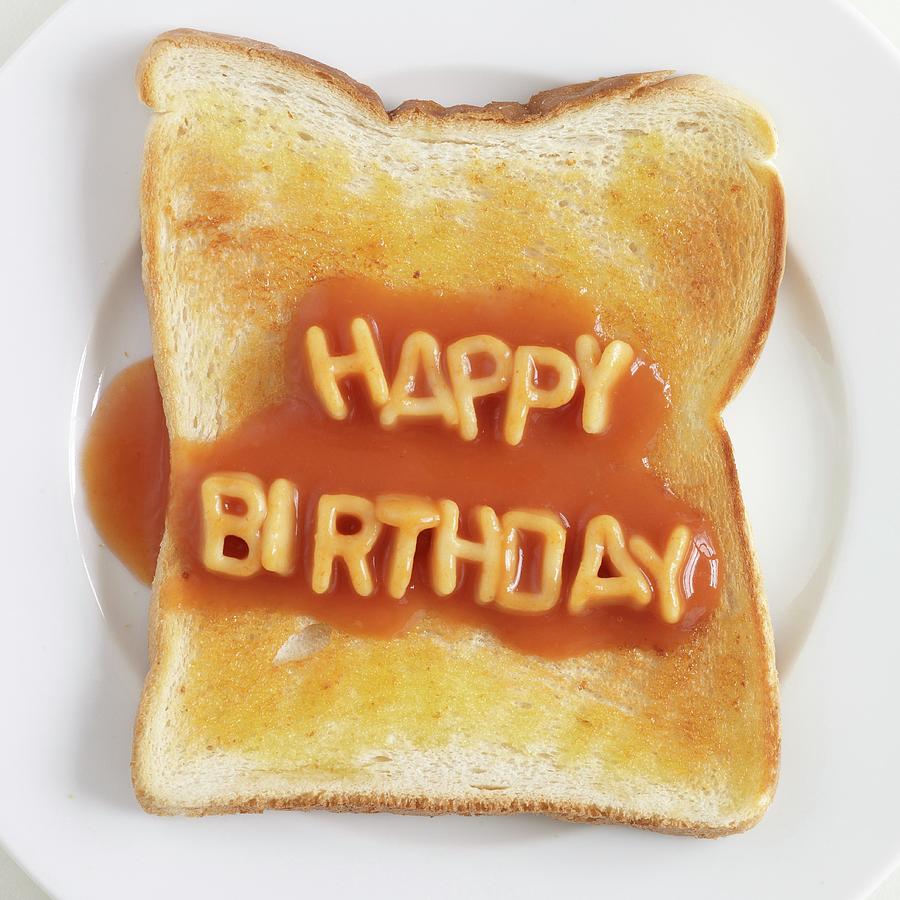 Toast Topped With Spaghetti Letters Spelling Out Happy Birthday Photograph by Ria Osborne