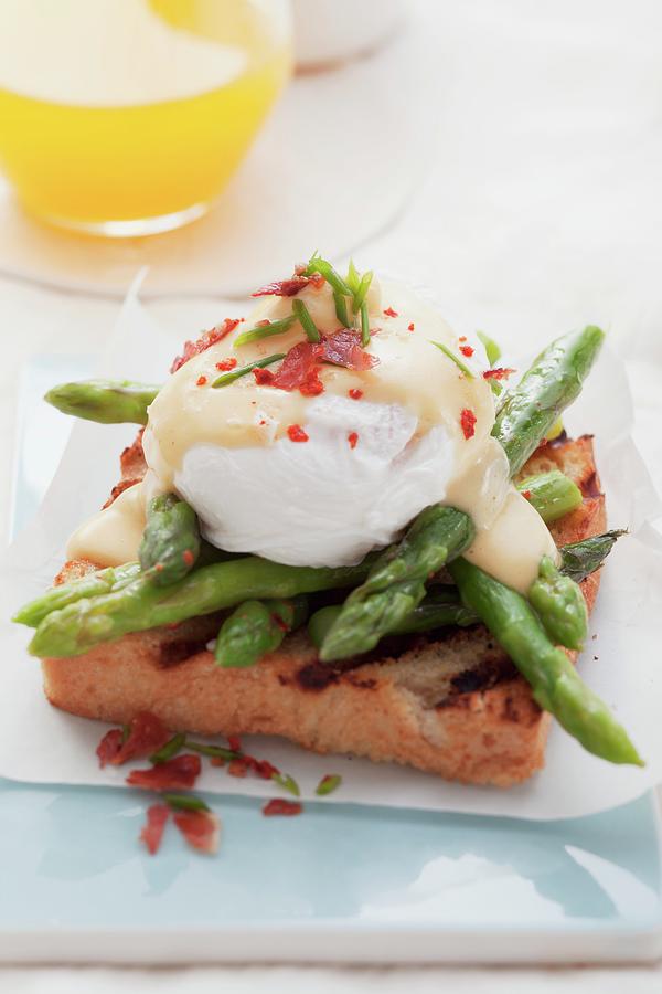 Toast With Asparagus And Eggs Benedict Photograph by Foodcollection