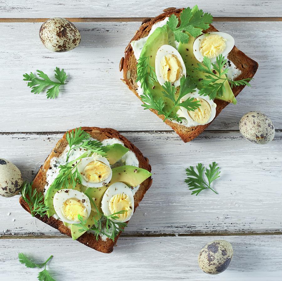 Toast With Avocado, Quails Eggs, Garlic Mayonnaise And Herbs Photograph by Charlotte Kibbles