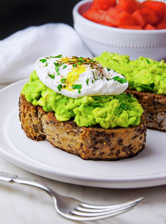 Toasted Multi-grain Bread Topped With Avocado Pure And A Poached Egg Photograph by Jennifer Blume