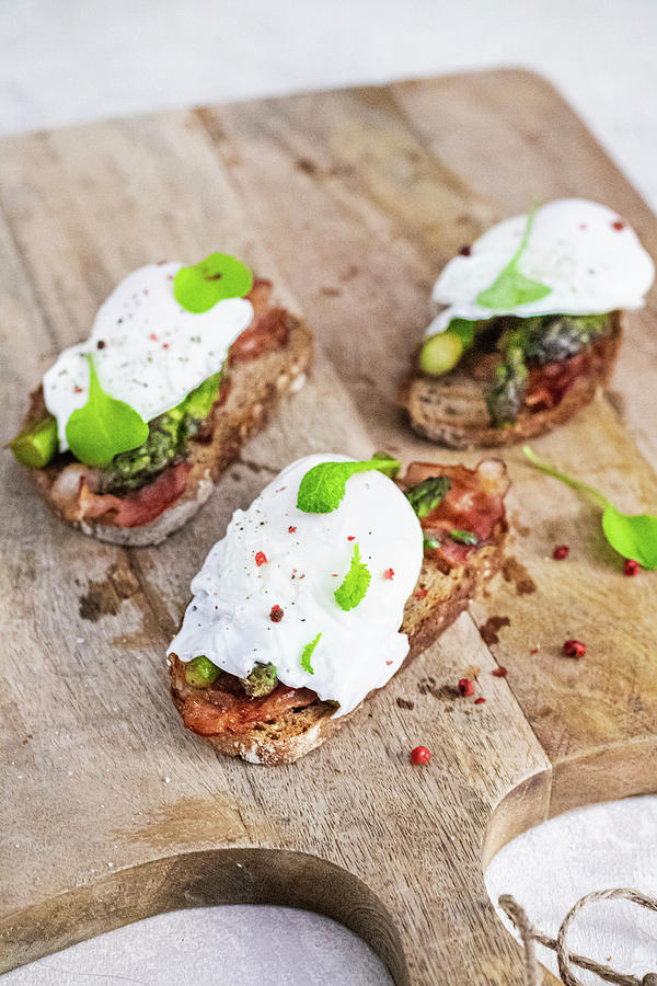 Toasts With Green Asparagus Bacon And Poached Egg Photograph by Karolina Nicpon