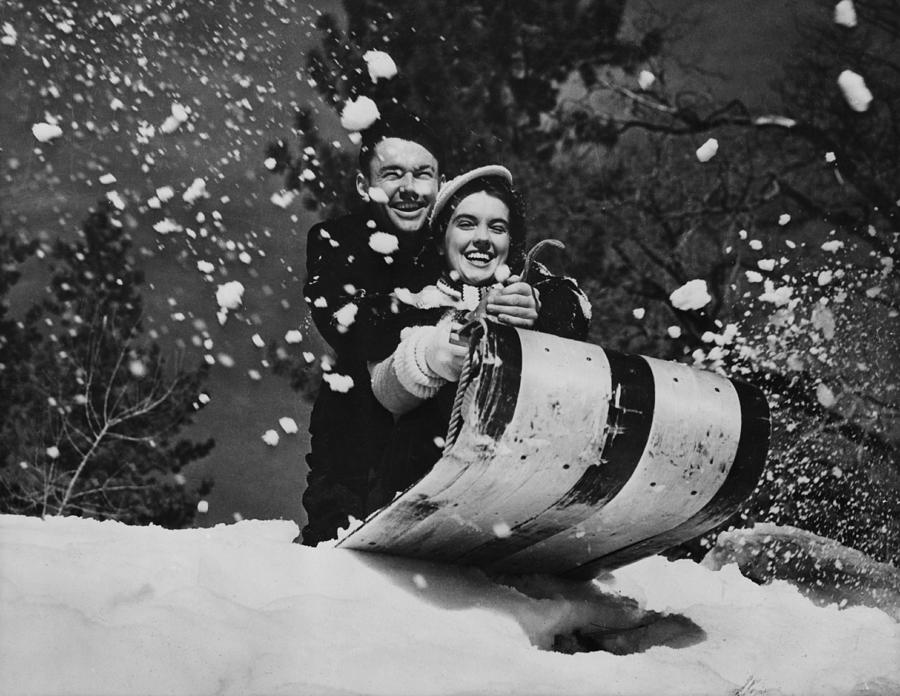 Tobogganing Couple Photograph by American Stock Archive
