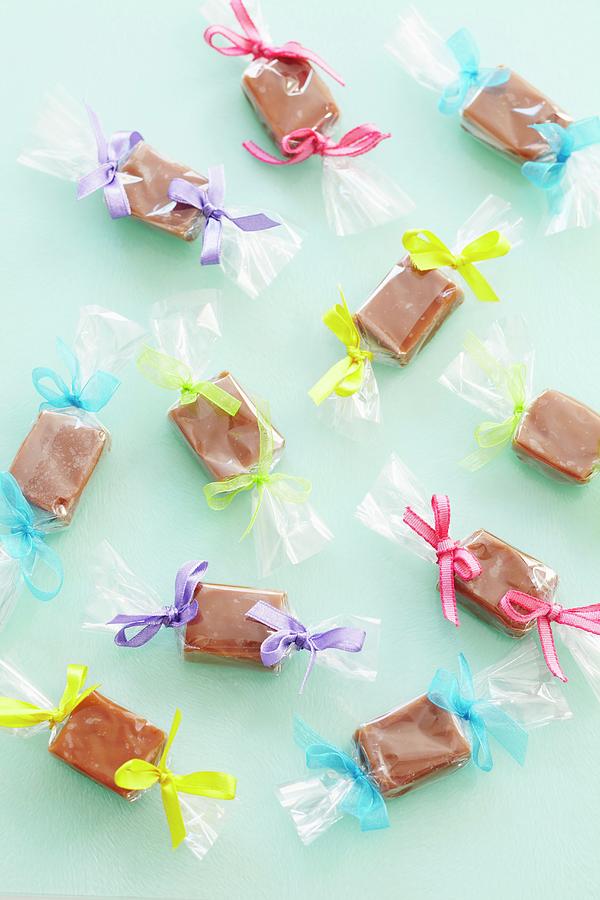 Toffee Bonbon Wrapped In Cellophane With Coloured Bows seen From Above