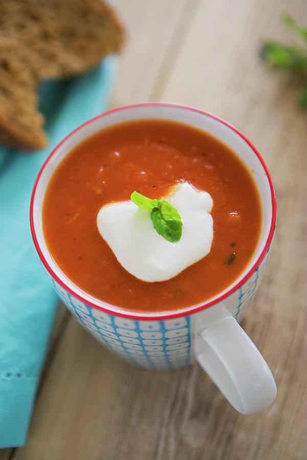 Tomato And Pepper Soup Served In A Mug With Crme Frache, Fresh Basil And Crusty Bread Photograph by Artfeeder