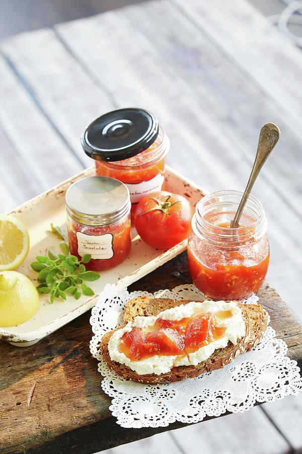 Tomato Jam In Jars And On Bread Photograph by Rafael Pranschke