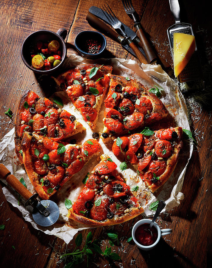 Tomato Pizza With Olives, Sliced On A Wooden Table Photograph by Vadim Piskarev