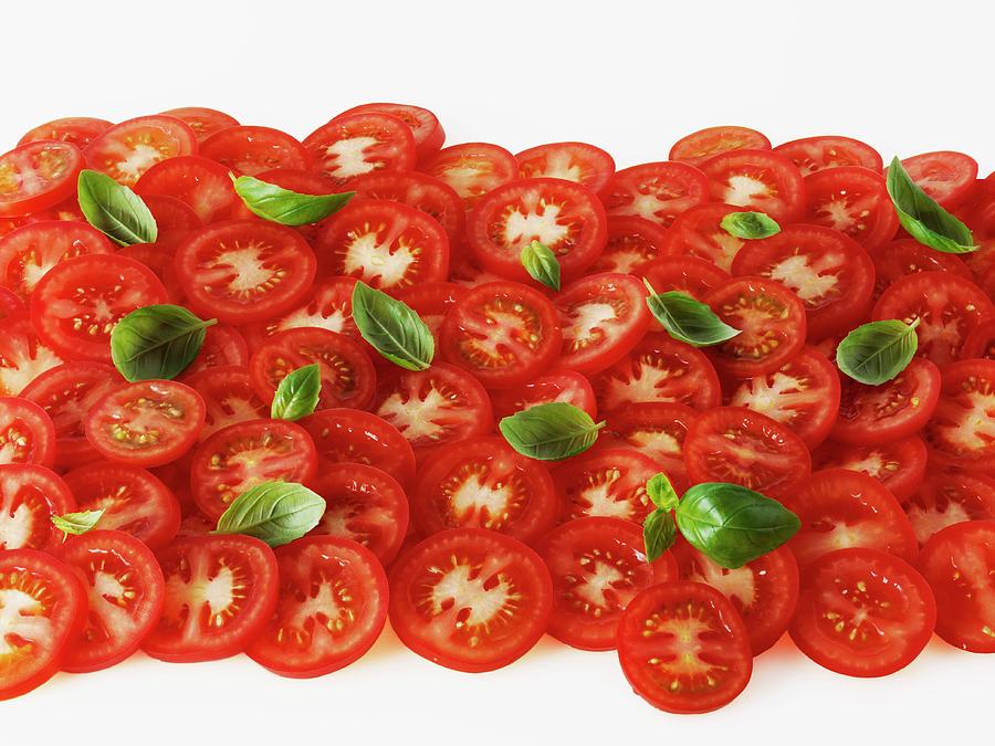 Tomato Slices And Basil Leaves Photograph by Frank Adam