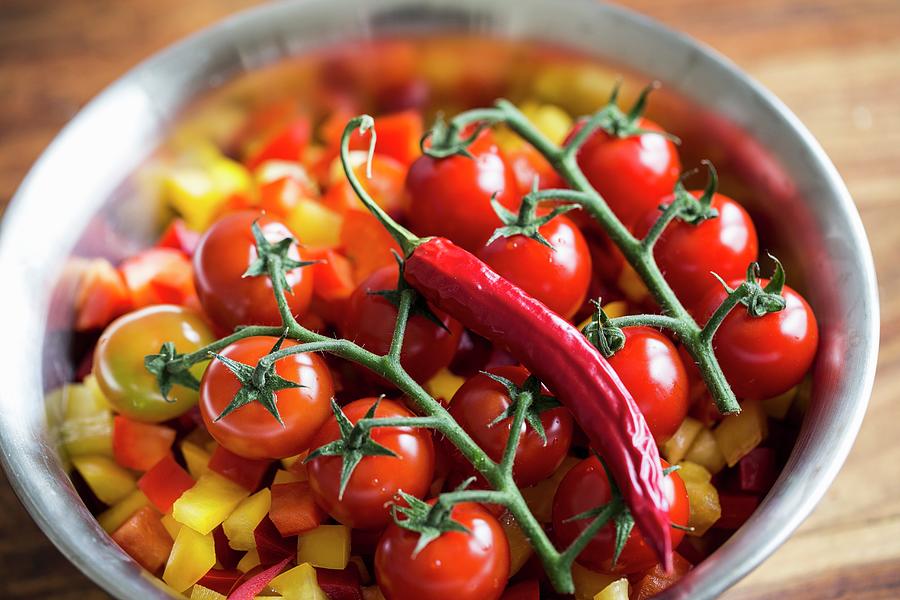 Tomatoes And Chillies On Chopped Peppers Photograph by Nicole Godt