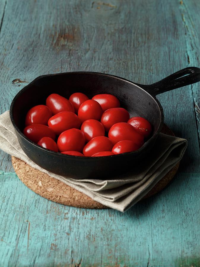 Tomatoes In A Cast Iron Pan Photograph by Rene Comet