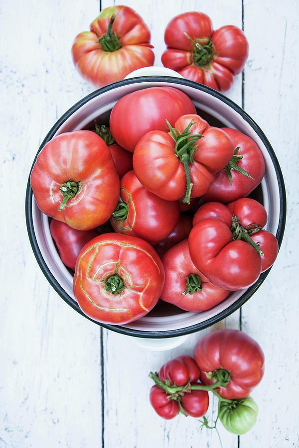 Tomatoes In A Pot Photograph by Nika Moskalenko