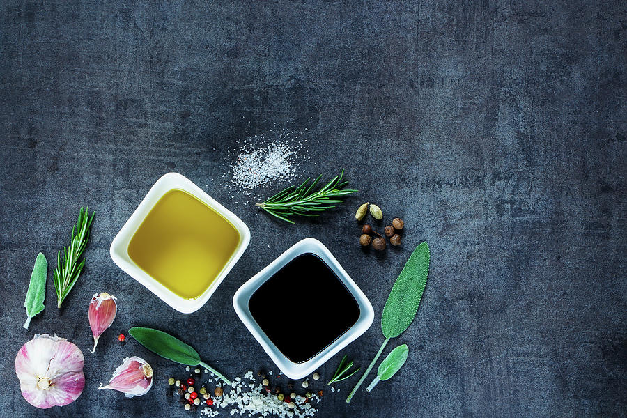 Top View Of Olive Oil And Vinegar With Peppercorns, Sea Salt, Garlic And Rosemary On Dark Vintage Background Photograph by Yuliya Gontar