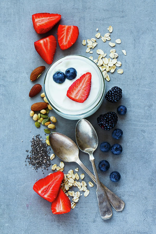 Top View Of Various Ingredients oat Flakes, Berries, Yogurt, Nuts And Chia Seeds For Breakfast Or Smoothie On Grey Vintage Background Photograph by Yuliya Gontar