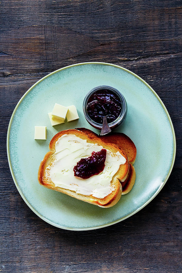 Top View Of Whole Grain Bread Toasts With Butter And Fruit Jam For Traditional Breakfast On Wooden Background Photograph by Yuliya Gontar