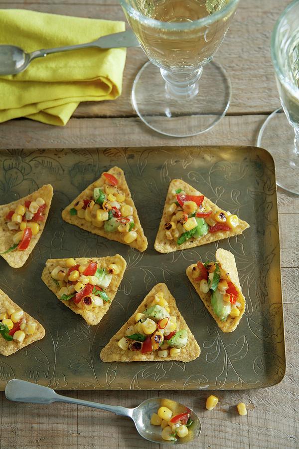 Tortilla Chips With A Sweetcorn And Avocado Salsa Photograph by Victoria Firmston