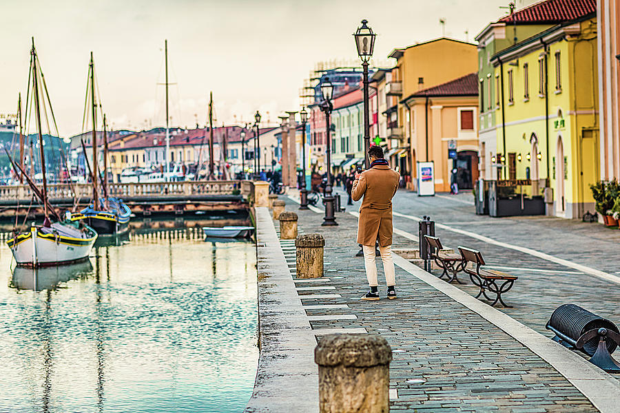 tourist takes photo of canal port of Cesenatico Photograph by Vivida Photo PC