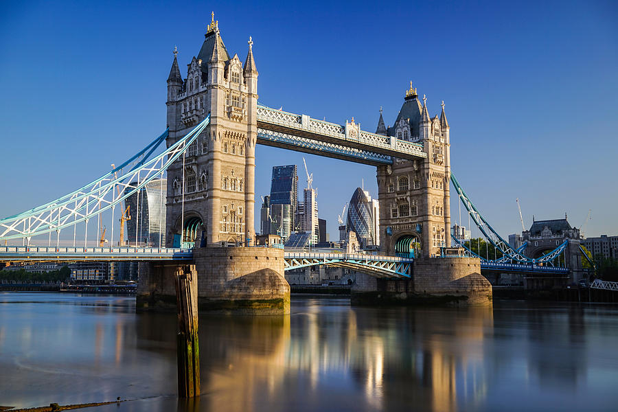 Tower bridge in London, England, seen on at sunrise on a clear day. Photograph by George Afostovremea