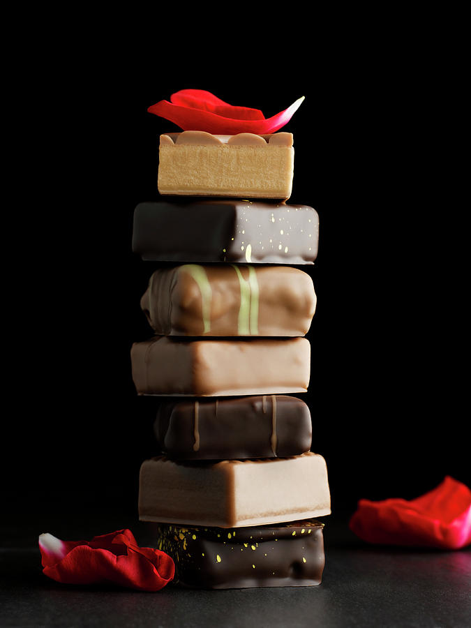 Tower Of Chocolates With Rose Petals On Photograph by Sabine Scheckel