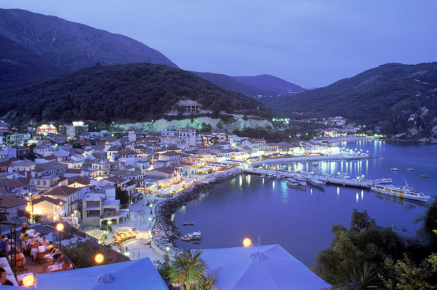 Town & Harbor At Night, Epirus, Greece Photograph by Walter Bibikow