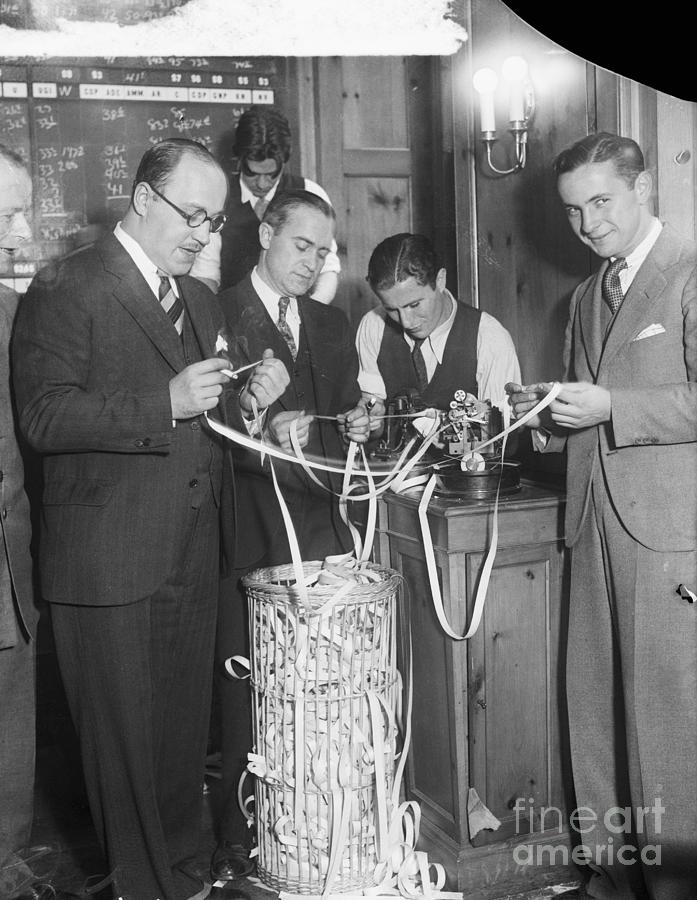 Traders Looking At Ticker Photograph by Bettmann