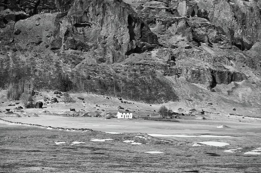 Traditional and Icelandic Turf Houses Below Dramatic Volcanic Cliff Black and White Photograph by Shawn OBrien